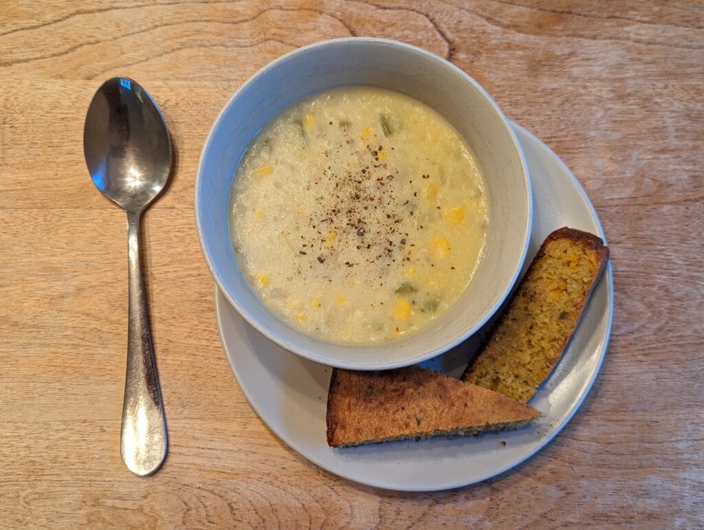 Bowl of hearty corn and potato soup with cord bread